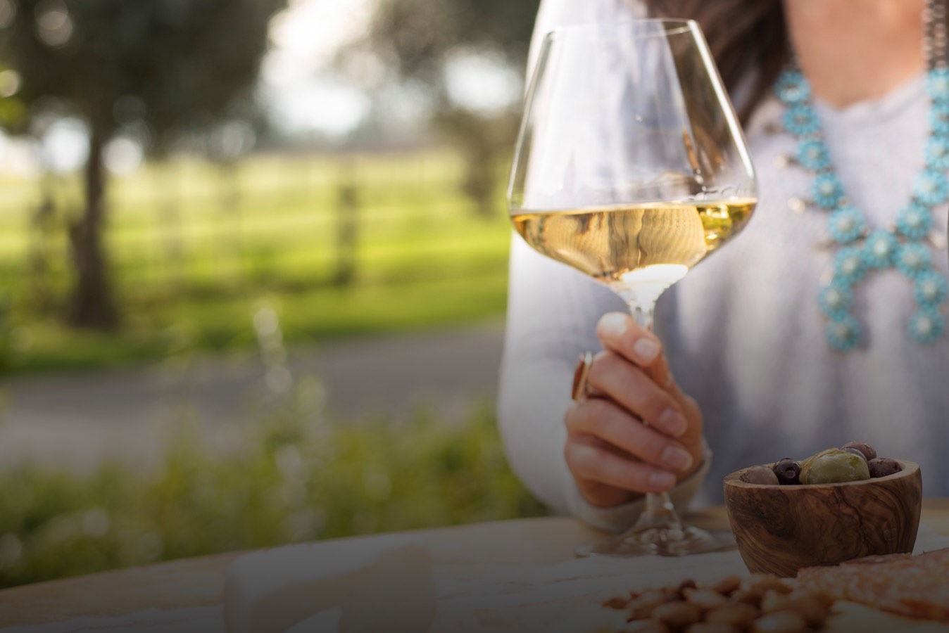 martin-ray-vineyards-and-winery-landing-slider-enjoy-our-events1@2x Hand holding wine glass